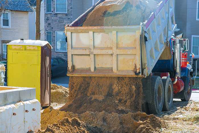 Truck Pouring Soil On Ground At Construction Site - Northeast MS Dirt Hauling Services - 2C Construction and Dirt Works - Dirt Hauling Tupelo & Northeast MS -